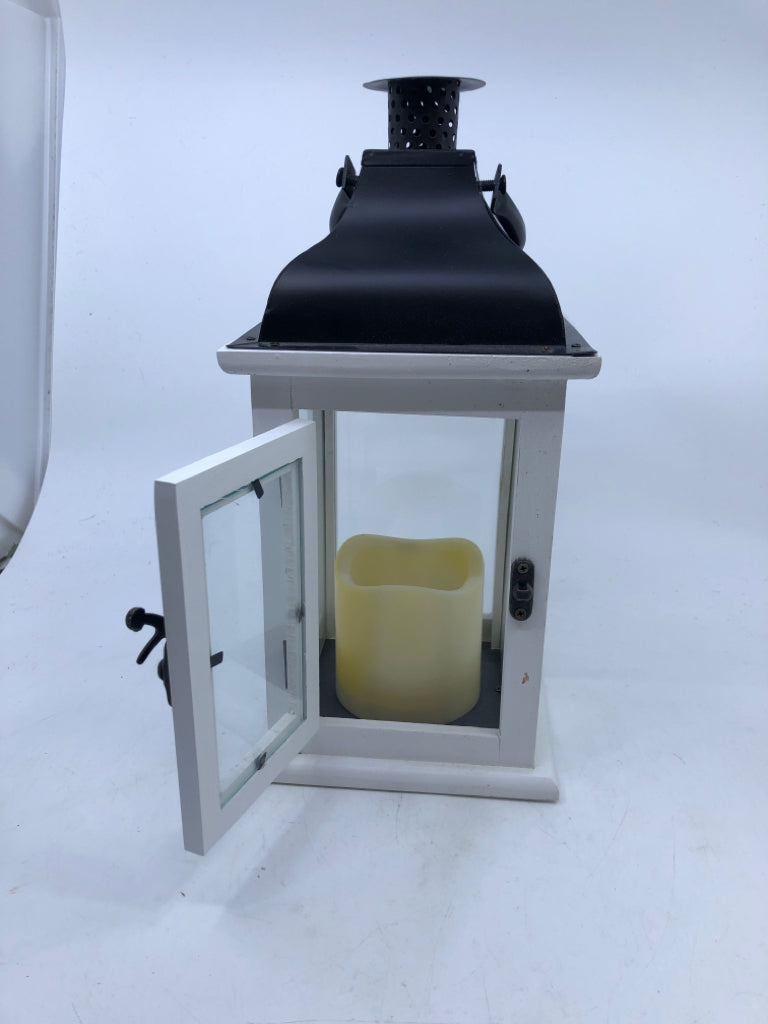 WHITE/BLACK LANTERN WITH FLICKERING CANDLE.