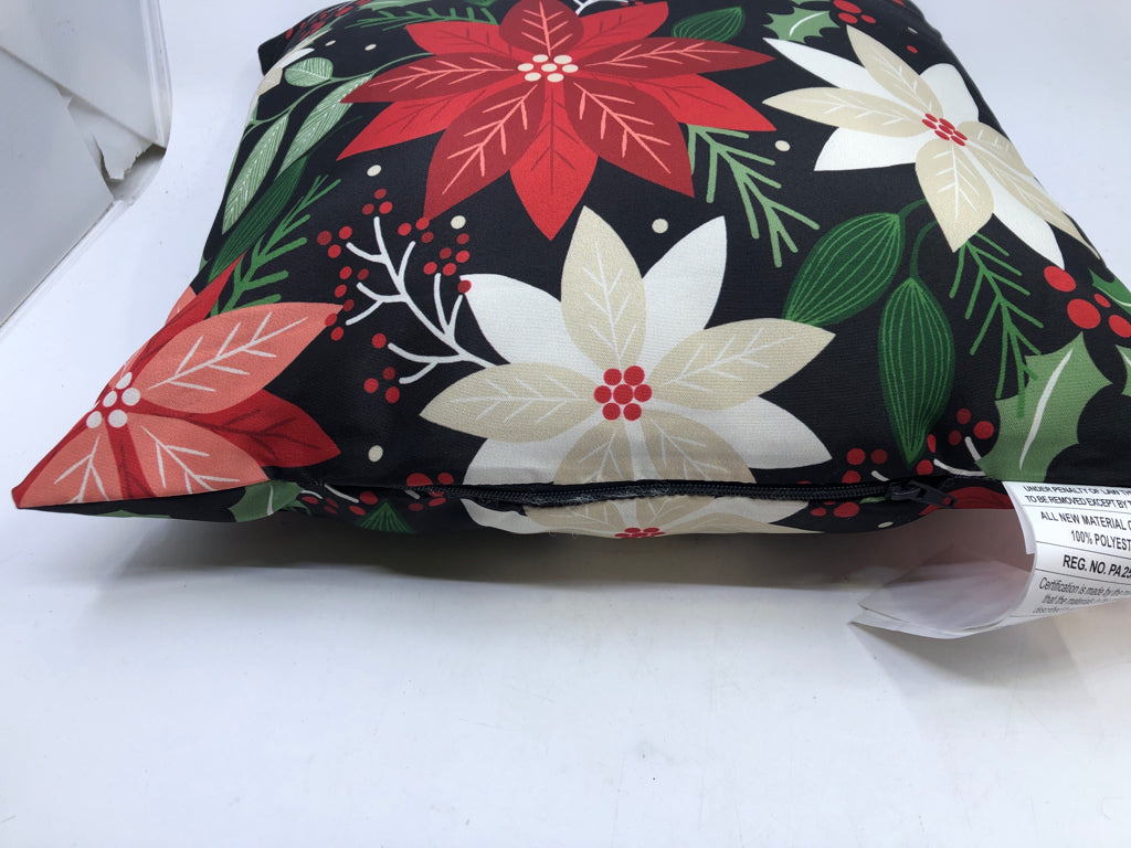 JOY BLACK ACCENT PILLOW WITH DECORATIVE FLOWERS.
