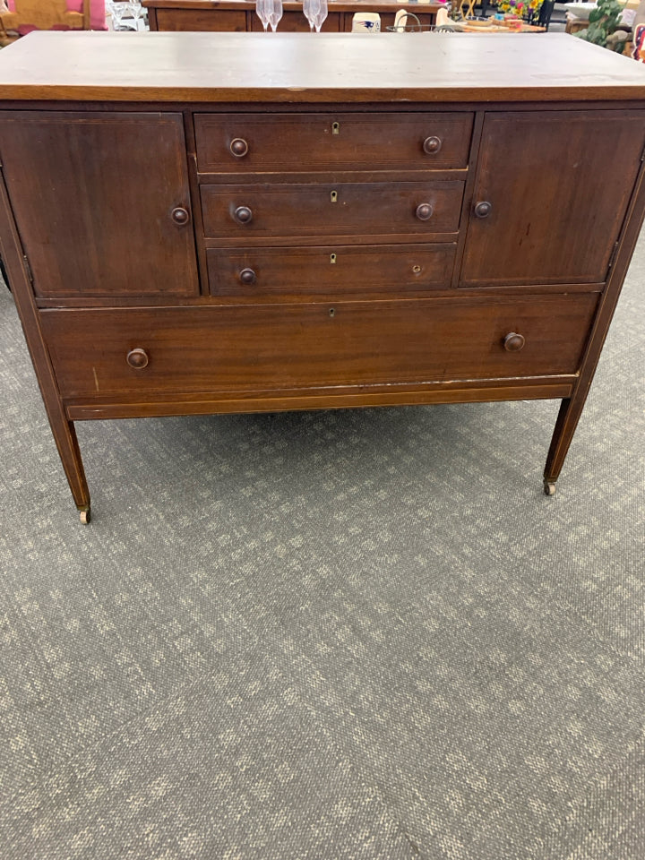 VTG DARK WOOD BUFFET 4 DRAWERS, 2 DOORS ON WHEELS.