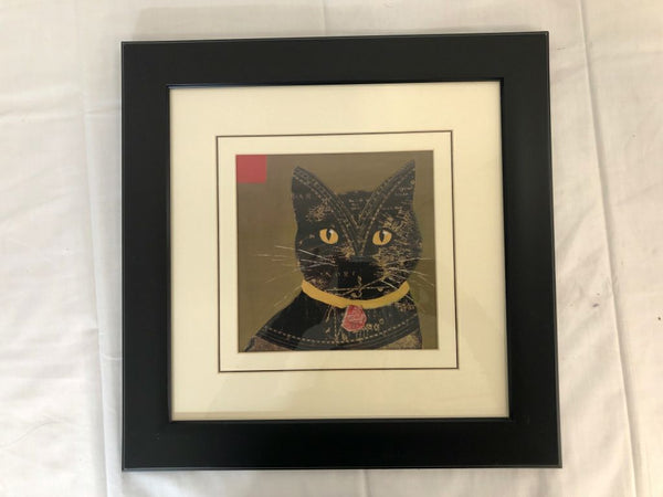 BLACK FRAME BLACK CAT WITH GOLD EYES AND COLLAR.