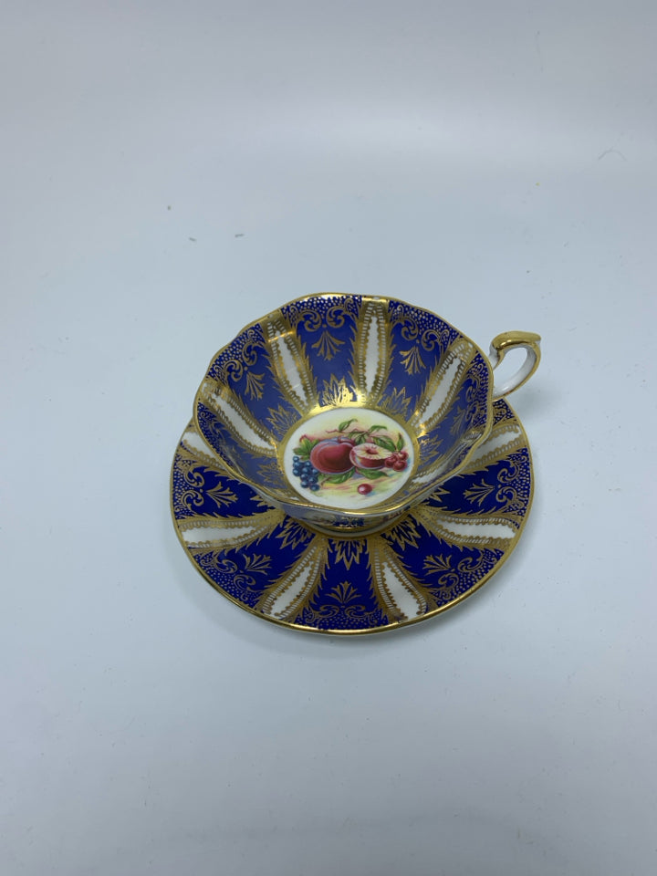 COBALT BLUE & GOLD DETAILED W/ FRUIT IN CENTER.