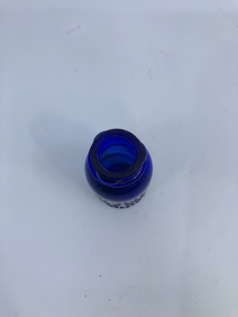 EMPTY COBALT BLUE SMALL BOTTLE W/ WRITING.