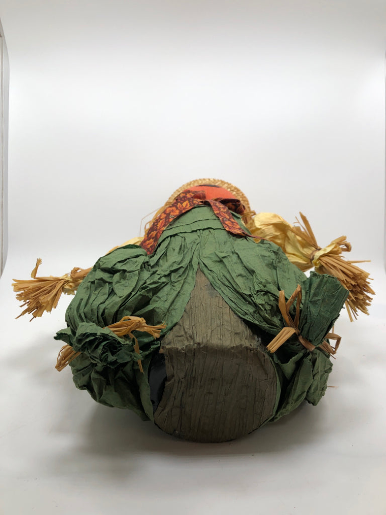 STRAW SCARECROW W/GREEN OVERALLS.