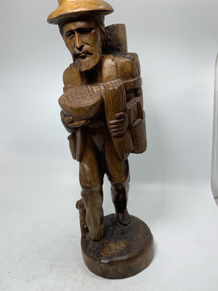 LARGE WOOD CARVED MAN W/ LARGE BACKPACK BAREFOOT WALKING.