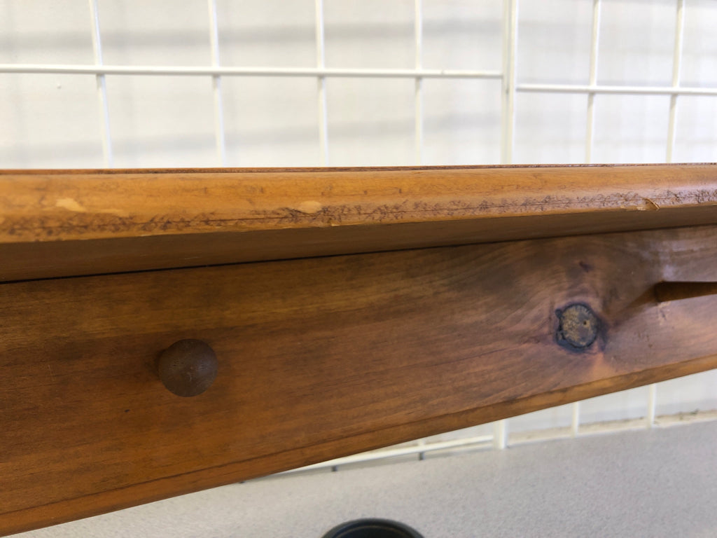 LIGHT BROWN WALL SHELF W/ COAT HOOKS.