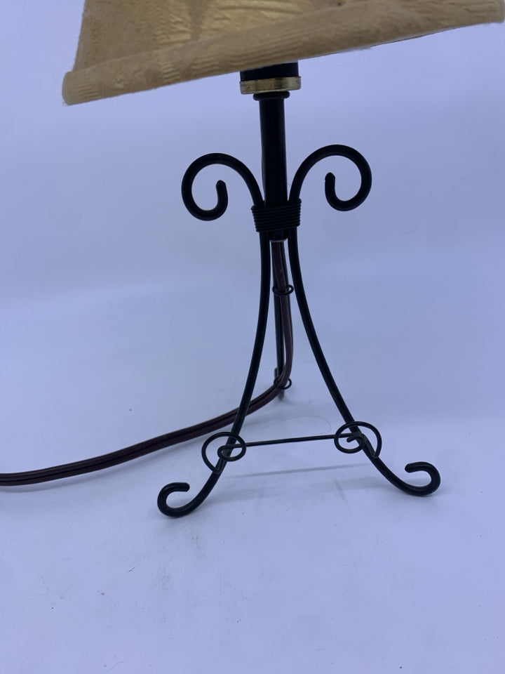 SMALL BLACK WROUGHT IRON TABLE LAMP WITH TAN SHADE.