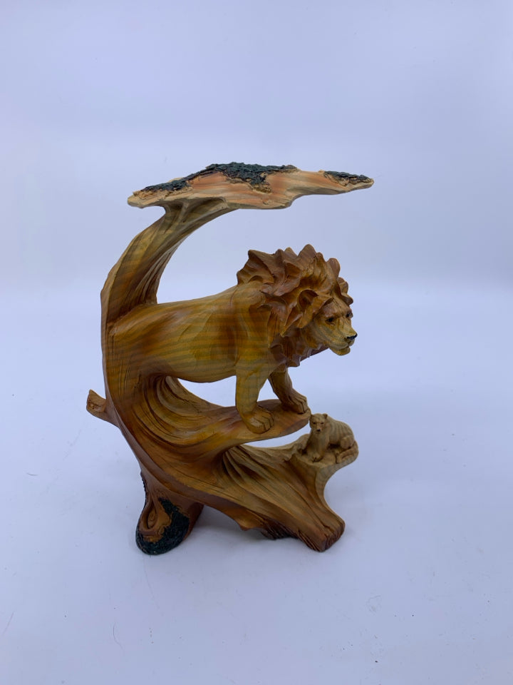 MALE LION ON ROCK COVERED BY TREE W/ LIONESS BELOW CARVED.