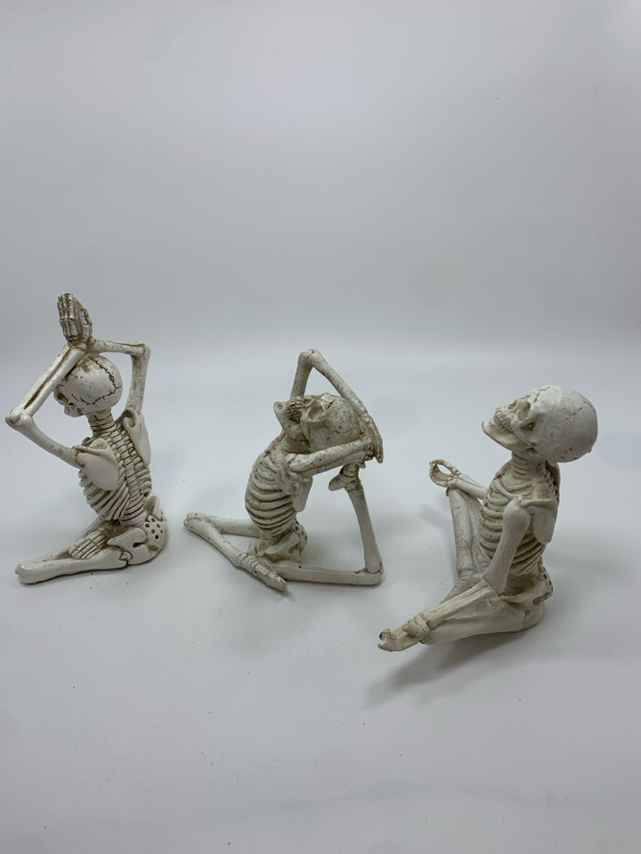 3 YOGA RESIN SKELETONS.