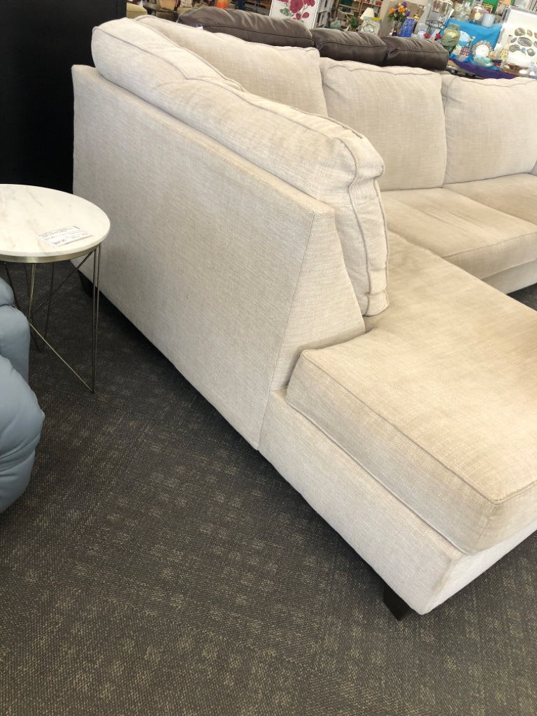 L-SHAPED CREAM COUCH.