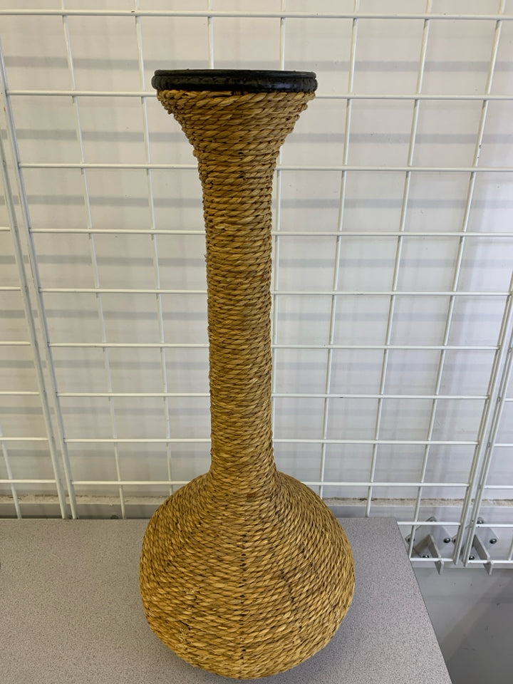 WOVEN RATTAN CANDLE HOLDER.