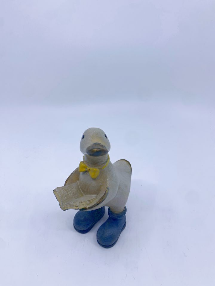 RESIN DUCK READING A BOOK W/ YELLOW BOW TIE.