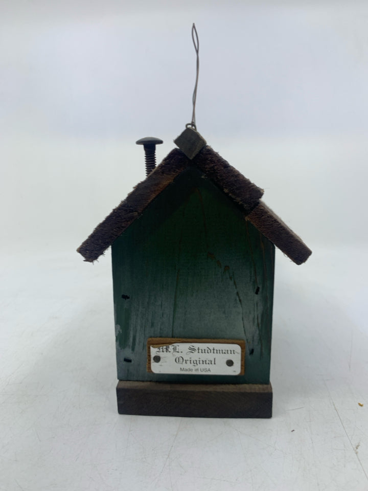 DISTRESSED GREEN CABIN W/ WINDOWS.