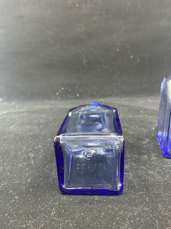 BLUE SQUARE GLASS OIL AND VINEGAR BOTTLES .