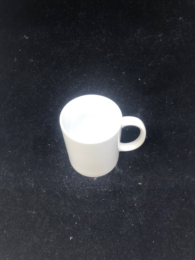 WHITE CERAMIC MUG.