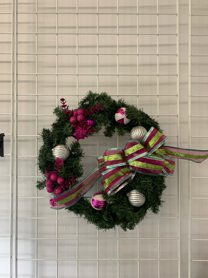 LARGE WREATH W ORNAMENTS AND PINK AND GREEN BOW.