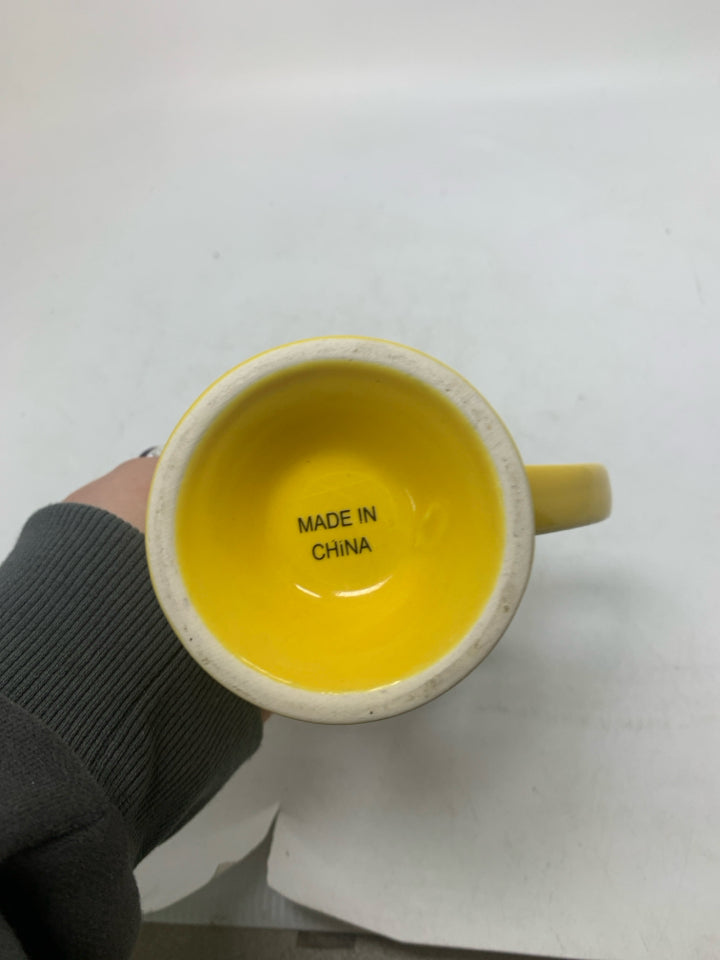 FOOTED SMILEY FACE MUG W/ BLUE INSIDE.