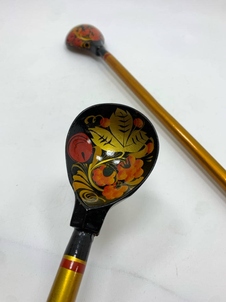 2 GOLD PAINTED LONG HANDLED WOODEN SPOONS.
