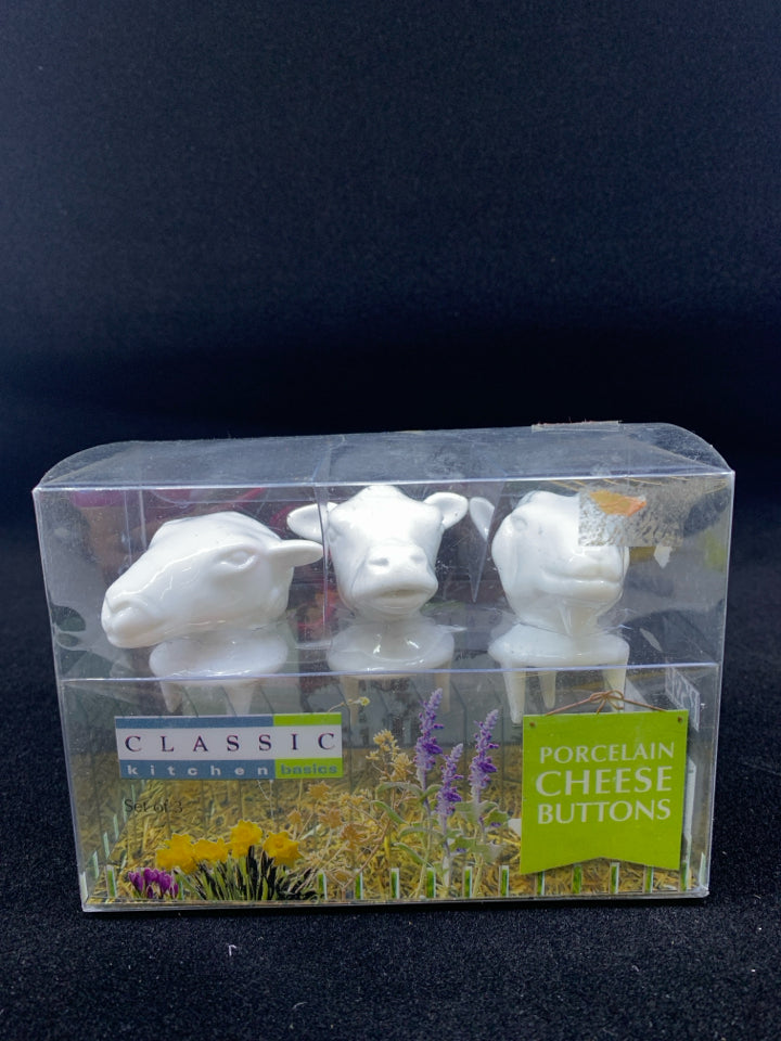 NIB COW PORCELAIN CHEESE BUTTONS.