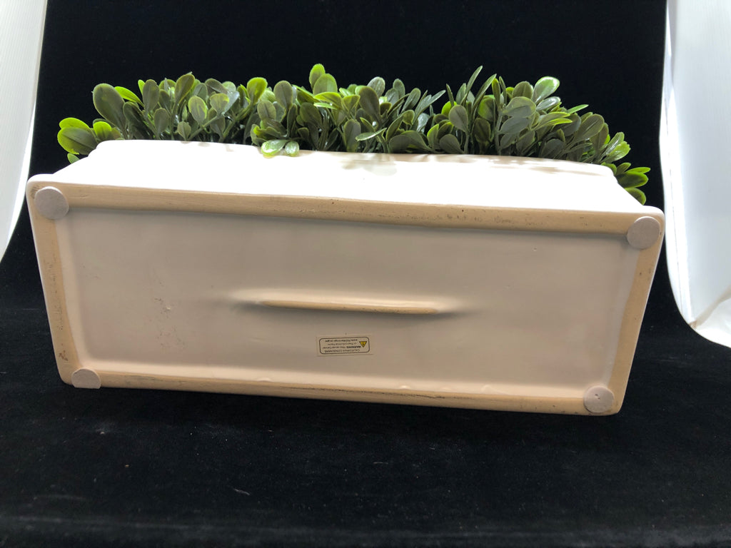 FAUX GREENS IN WHITE CERAMIC PLANTER.