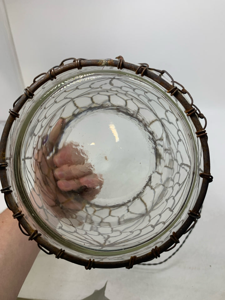 LARGE GLASS JUG W/ RUSTED METAL CAGE HANGING LANTERN.