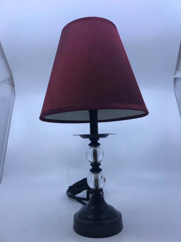SMALL BLACK/CLEAR BASE LAMP W/ RED SHADE.