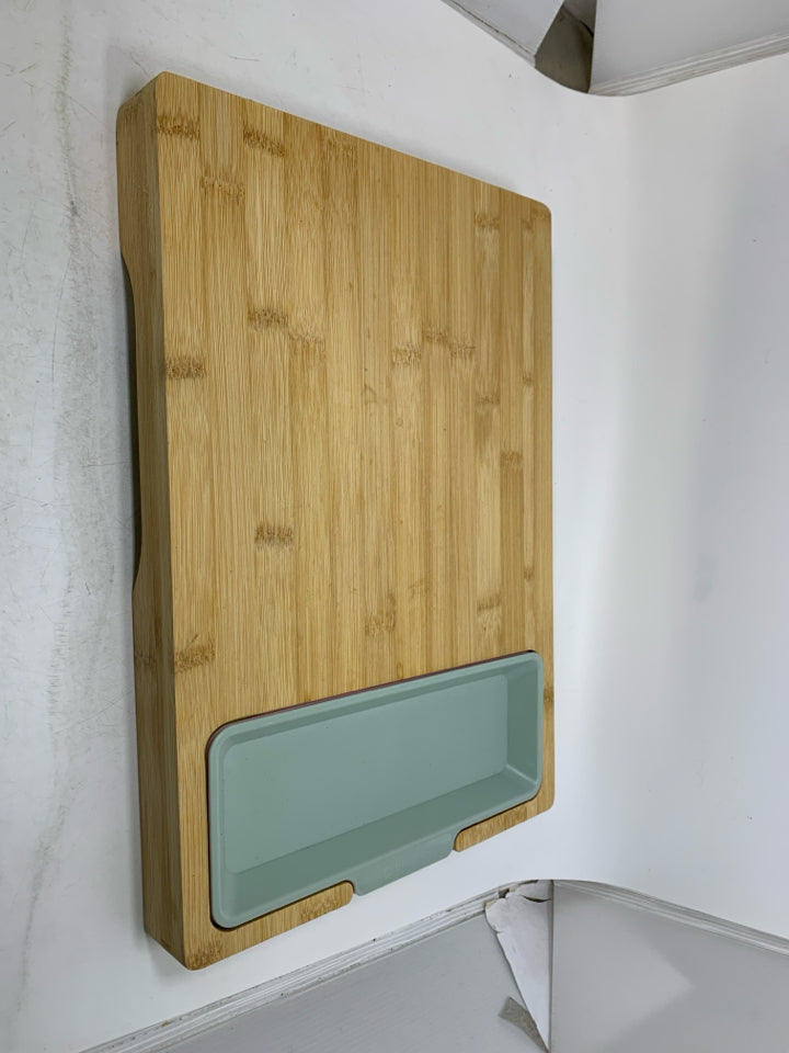 WOOD CUTTING BOARD W/ PLASTIC INSERTS.
