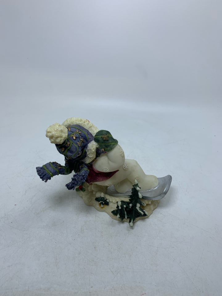 RESIN SNOWMAN ON SNOWBOARD.