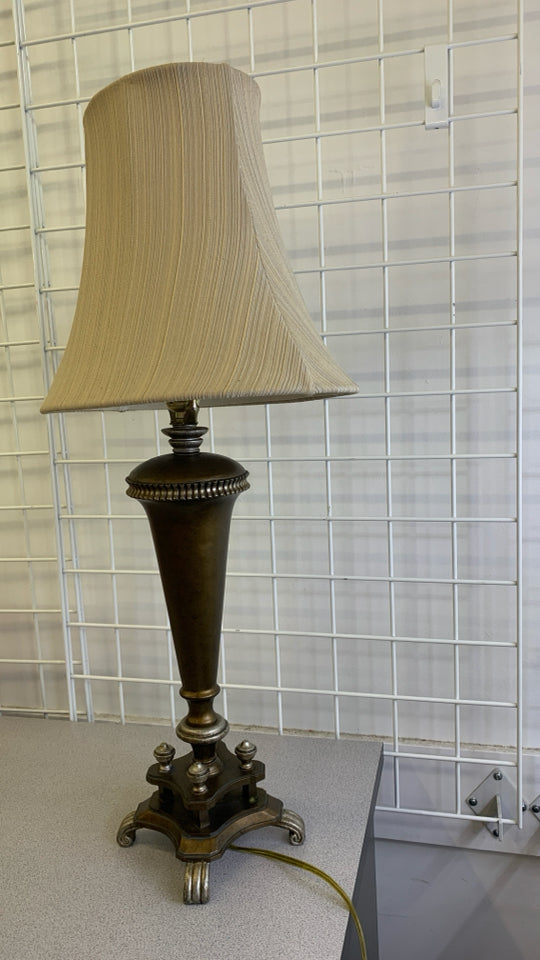 BRONZE BASE TABLE LAMP W/TAN TEXTURED STRIPE SHADE.