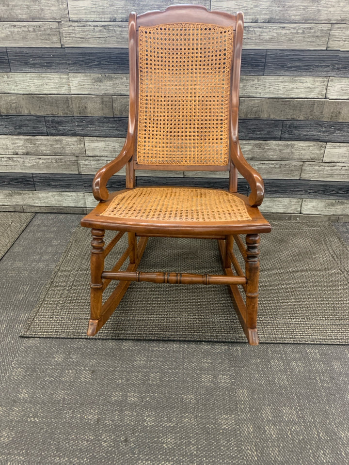 VINTAGE DARK BROWN CANE SEAT ROCKER.