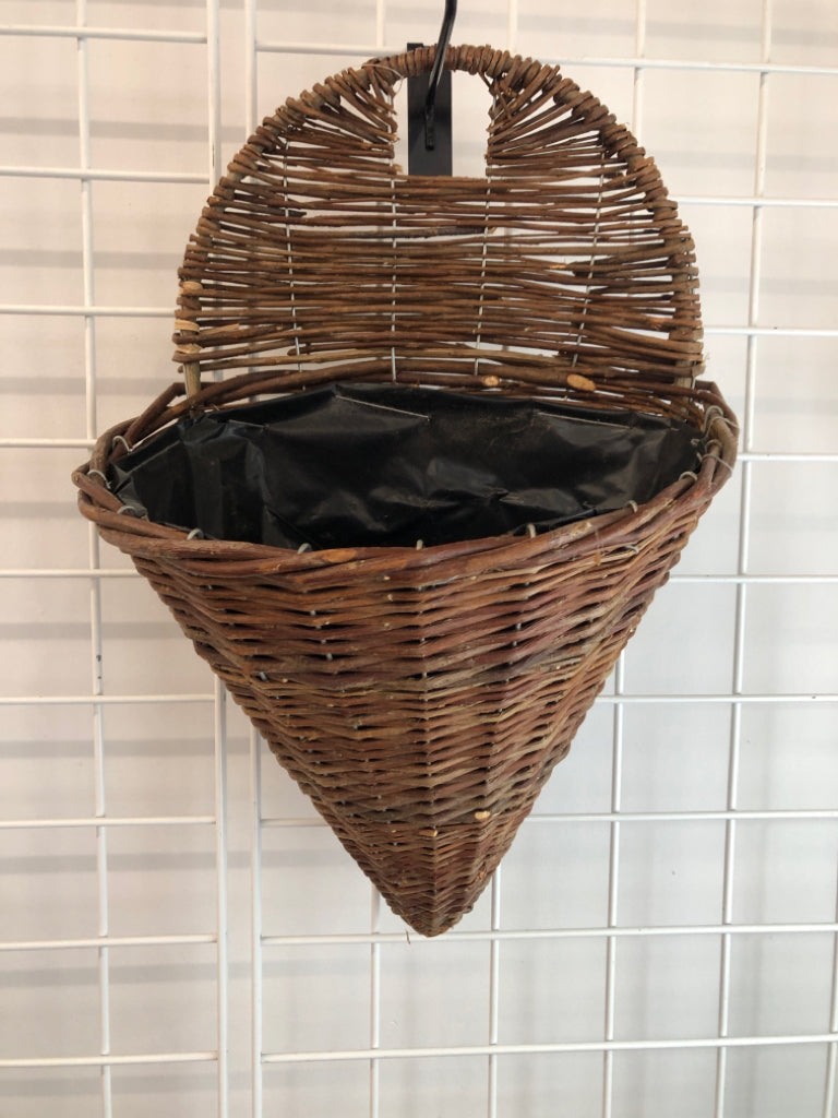 BROWN WICKER WALL PLANT HOLDER.