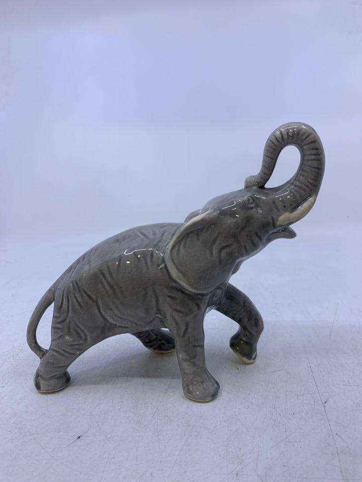 LIGHT GREY WALKING ELEPHANT W/ TRUNK UP.