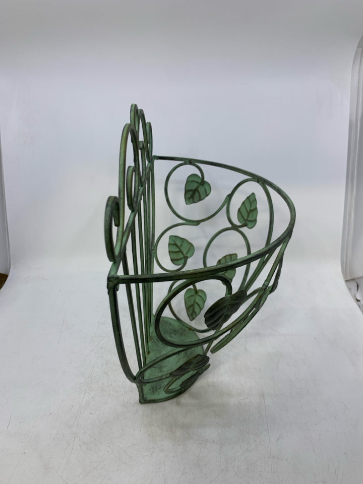GREEN METAL WALL POCKET W/ LEAVES.