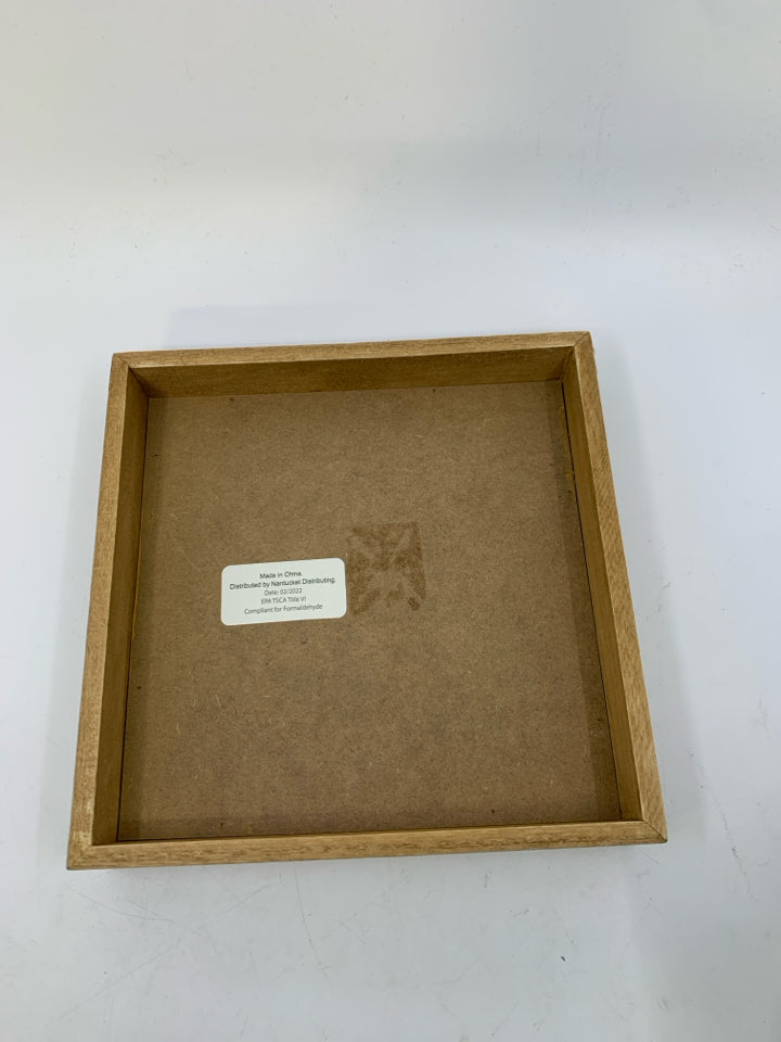 WOOD FRAME W/ ORANGE MEDALLION.