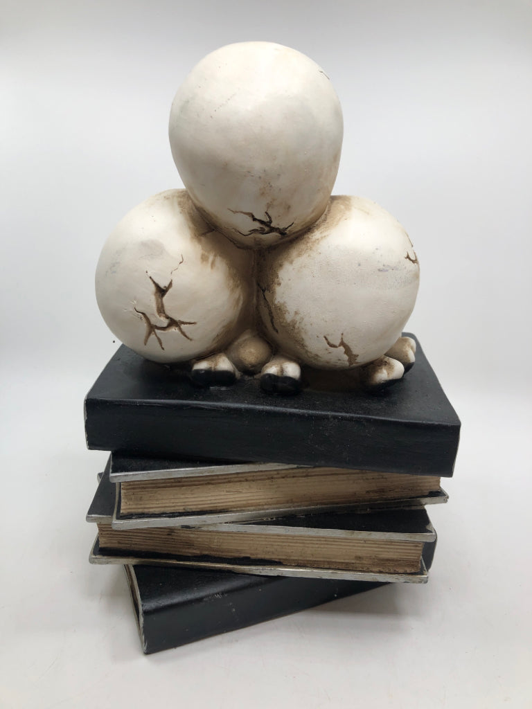 SKULLS ON BOOK STACK RESIN FIGURE.