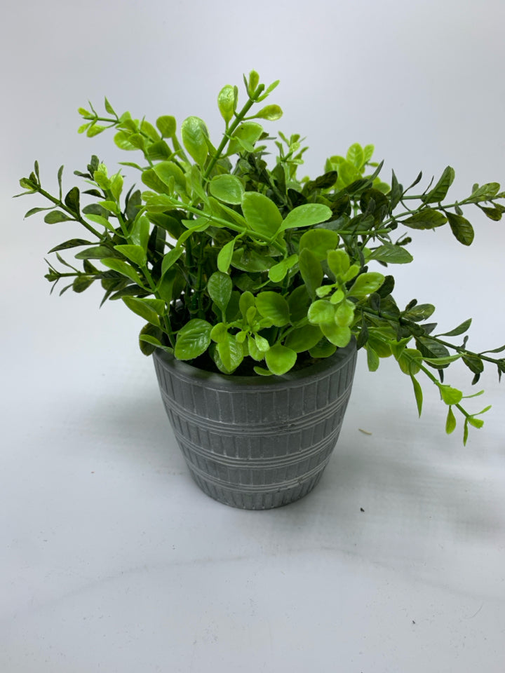 GREY W/ WHITE LINES PLANTER W/ FAUX LEAVES.