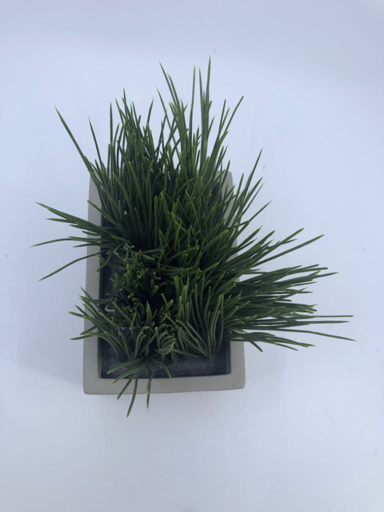 FAUX GRASS IN SQUARE PLANTER.