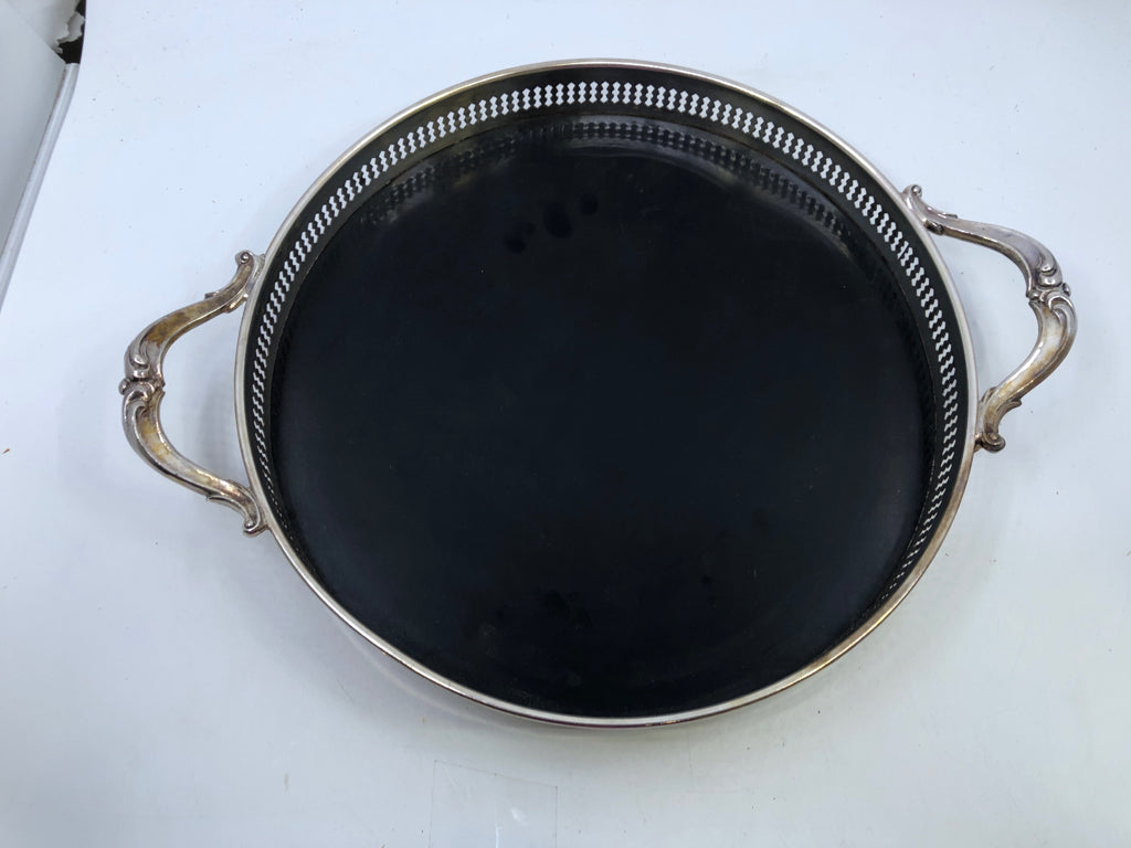 VTG SILVERPLATED FOOTED CIRCLE TRAY W/ BLACK BOTTOM FORMICA HANDLES.