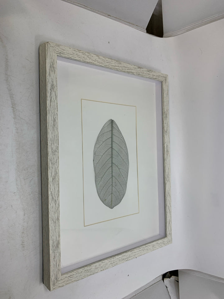WHITE FRAME SHADOW BOX W/ LEAF IN CENTER.