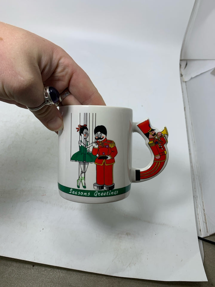 WHITE MUG W/ NUTCRACKER HANDLE "SEASON GREETINGS".