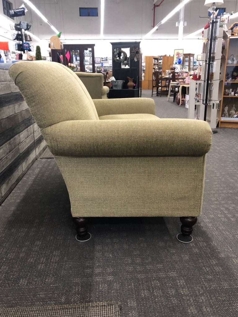 ARTICHOKE GREEN LOVE SEAT W/ BROWN WOOD LEGS.