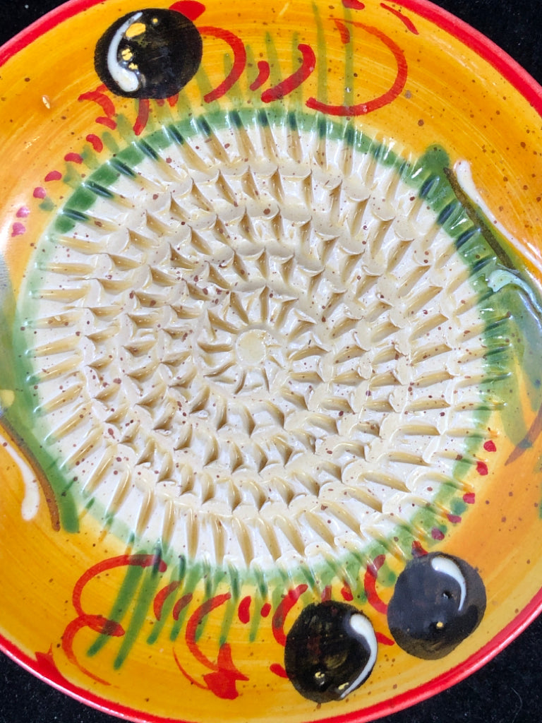 MUSTARD YELLOW W RED ACCENTS GARLIC GRINDER.