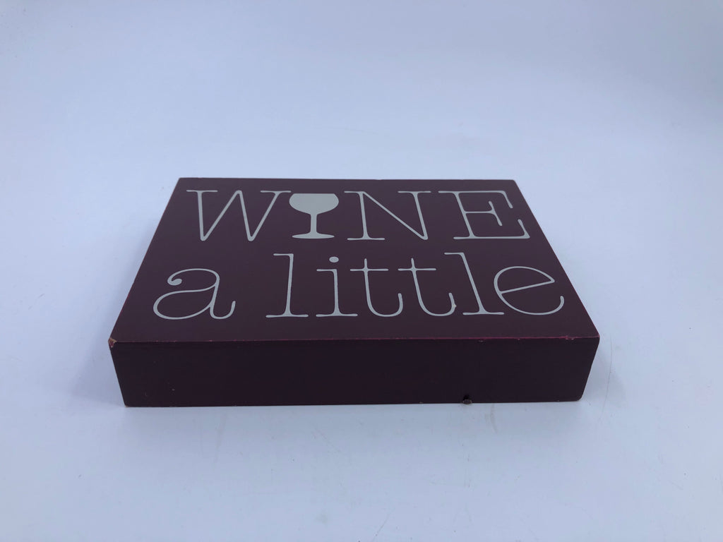 WINE A LITTLE BLOCK SIGN.