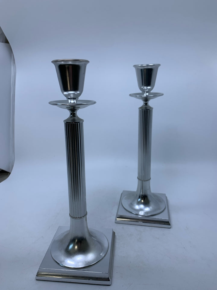 2 TALL SILVER METAL PILLAR CANDLE HOLDERS.