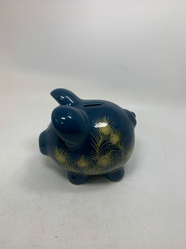 DARK BLUE PIGGY BANK W/ PEACOCK FEATHER DETAILS.