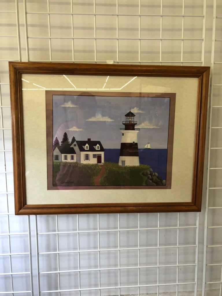 LIGHTHOUSE NEXT TO A WHITE HOUSE ON THE WATER WALL ART.