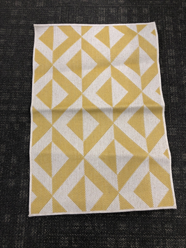 TAN/YELLOW PATTERNED RUG.