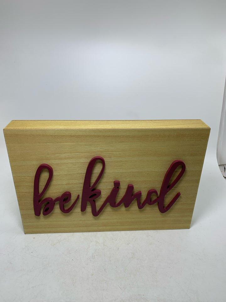 BE KIND IN MAROON LETTERS SIGN.
