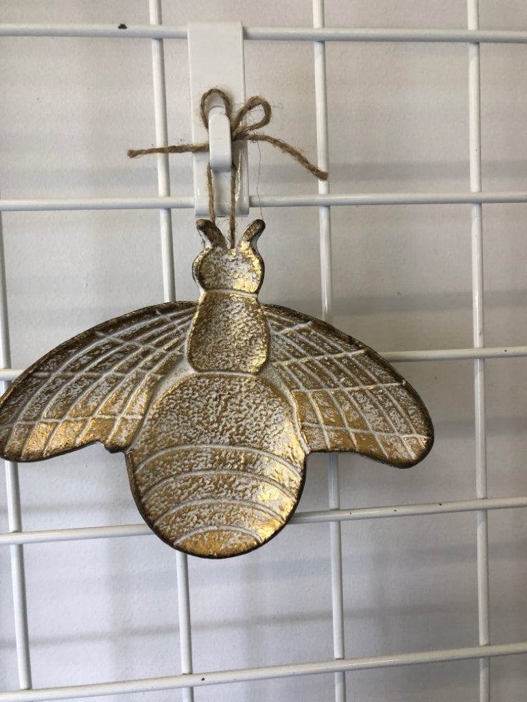 HEAVY CAST IRON BEE W WHITE AND GOLD ACCENTS.