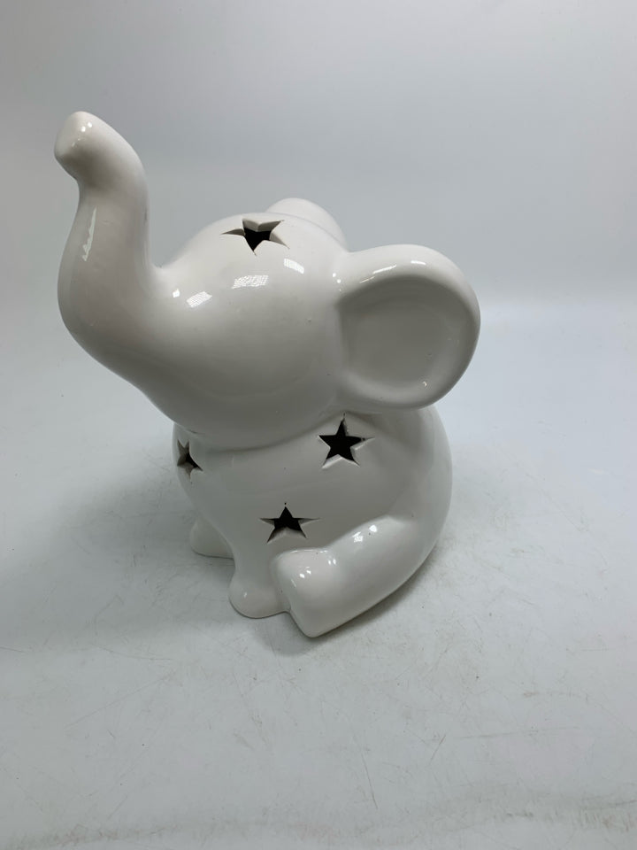 WHITE CERAMIC SITTING ELEPHANT W/ PIERCED STARS.