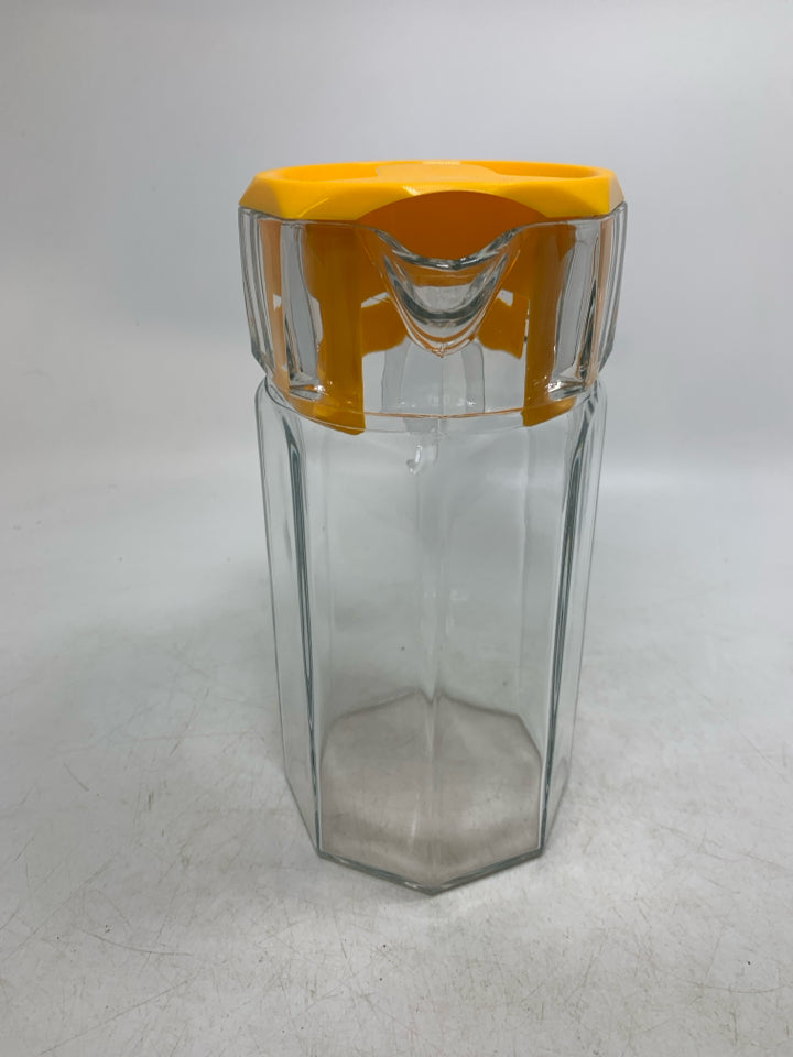 GLASS OCTAGON SHAPE SHAPE PITCHER W/ YELLOW LID.
